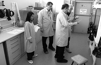 Photo of 4 inspectors and representatives wearing white lab coats.