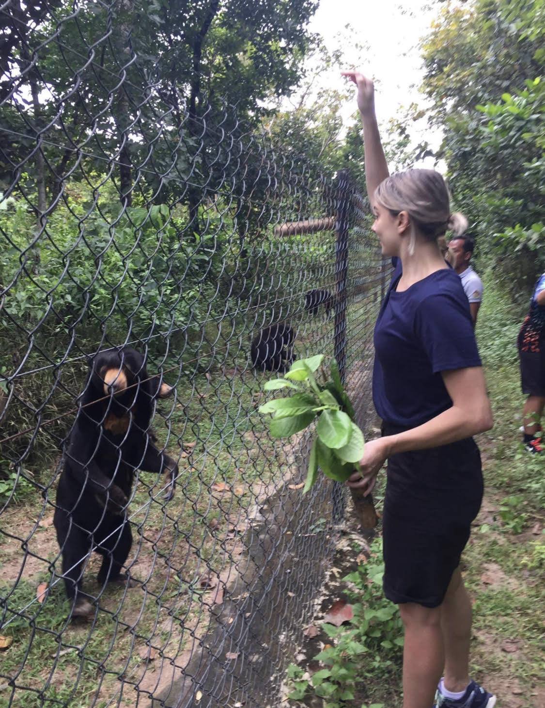 Gamilaroi woman, Jasmyne Mehrton-Johnson feeding bears in Cambodia