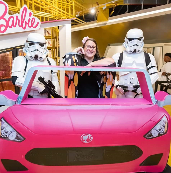 Jessica posing with Storm Troopers and a Barbie car at a Mattel event as part of her internship at the toy company.