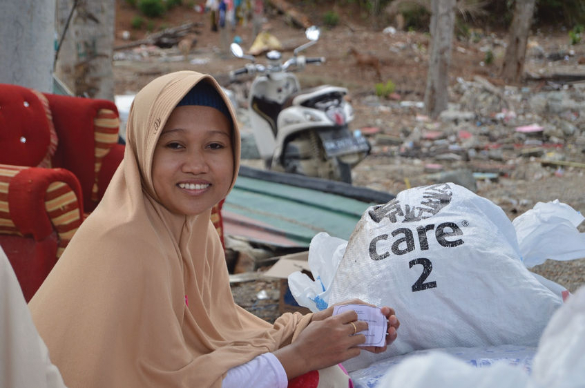 Woman in Donggala District, Indonesia waiting for distribution of Australian relief supplies following the Sulawesi earthquake [CARE/PKPU Human Initiative/Wiwik Widyastuti]