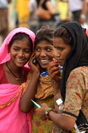 Young women using a mobile phone in New Delhi, India.