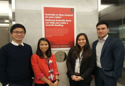 Interns standing in front of lifts and an NAB poster