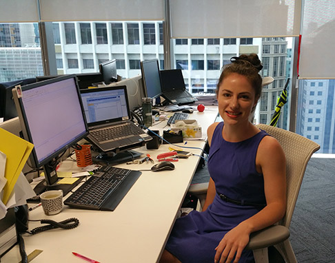 Rebecca sitting at her office desk