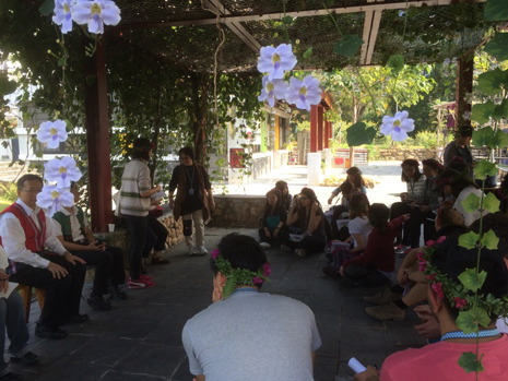 NCP students sitting in a circle in a covered courtyard