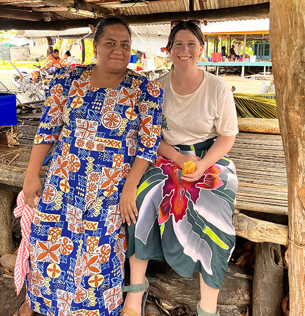 Jess Rodham sitting with a local resident of Nui Island