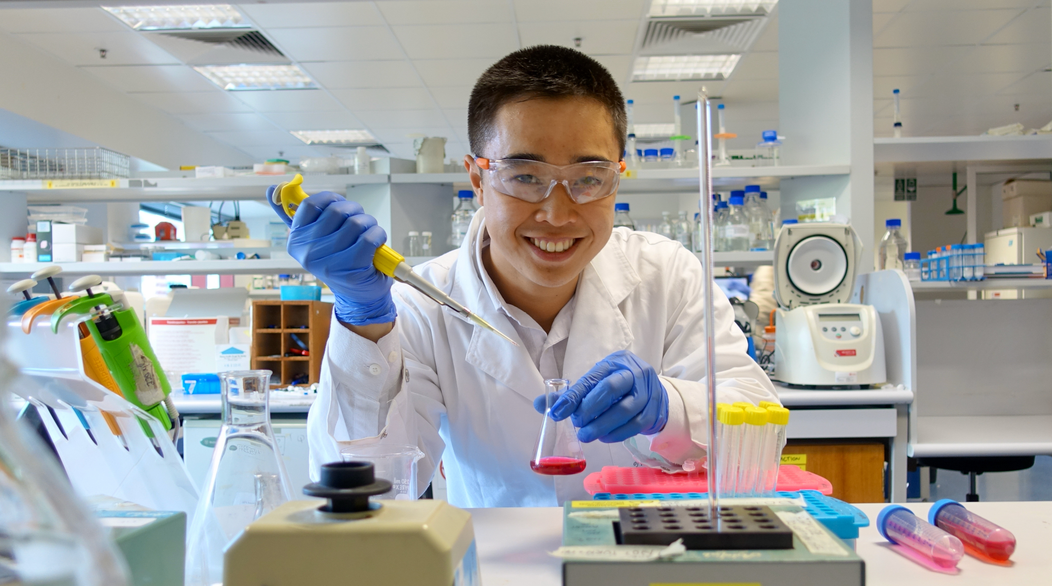 Andy Tran in a lab exercising his skills as a Chemical Engineering.