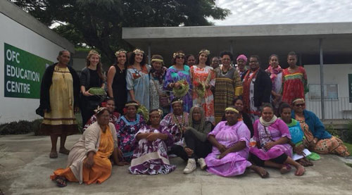 Ella and her mother posing for a photo with female anaak leaders.