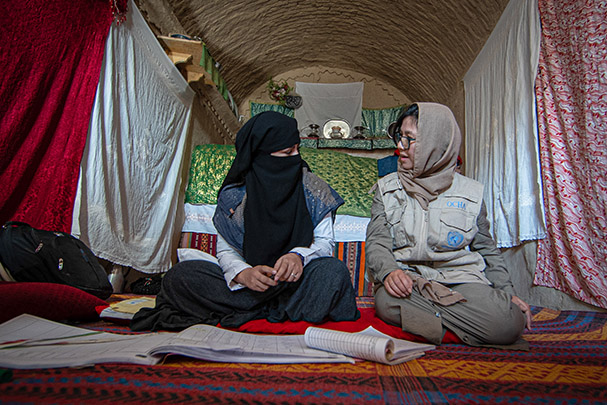 OCHA staff and nurses in charge of a local mobile clinic in Kandahar region. Once a week a family lends a room inside their own house for the nurses and medical team to open family consultations. 