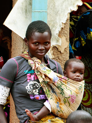 Photo of a young woman holding a child.