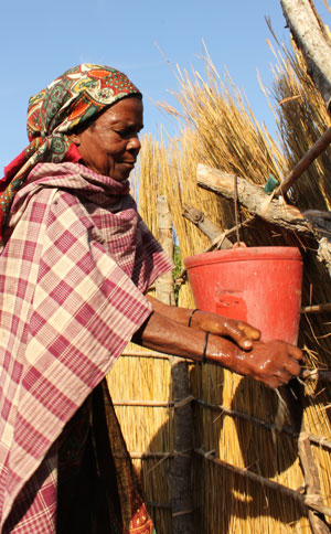 Photo of a woman washing her hands in a latrine system.