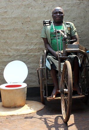 Photo of a disabled man next to his accessible toilet.