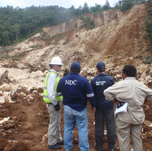 Reps from Exxon Mobile, AusAID and the NDC inspect the site of the landslide.