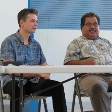 Charge d'Affaires Michael Kulesza sitting at a desk talking to Pohnpei State Governor John Ehsa