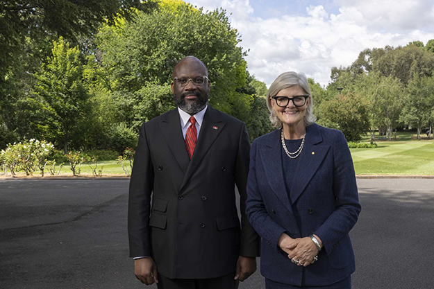 A man and a woman standing side-by-side outside.