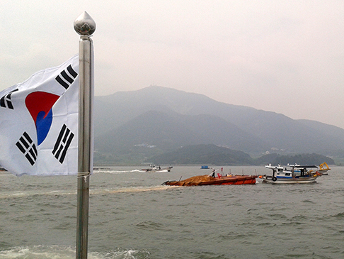 Clay application in sea, with Korean flag in foreground