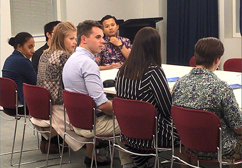 Attendees sitting at conference table