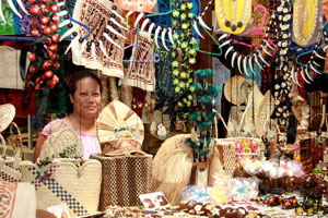 A woman surrounded by her products at a market stall