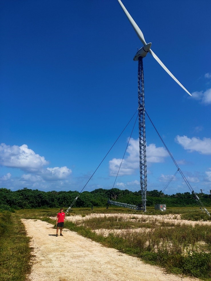 2019 New Colombo Plan Scholar, Sarel Steinauer, at the Tonga Niutoua wind site during his internship with the Pacific's Centre of Excellence on Renewable Energy and Energy Efficiency. Photo credit: Solomone Fifita (Manager at Pacific Centre for Renewable Energy & Energy Efficiency)