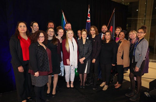 Photo of DFAT Secretary Frances Adamson, Isaiah Firebrace and members of the Indigenous Employees Network on a stage.