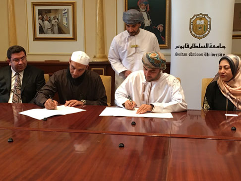 Photo of two people signing documents.