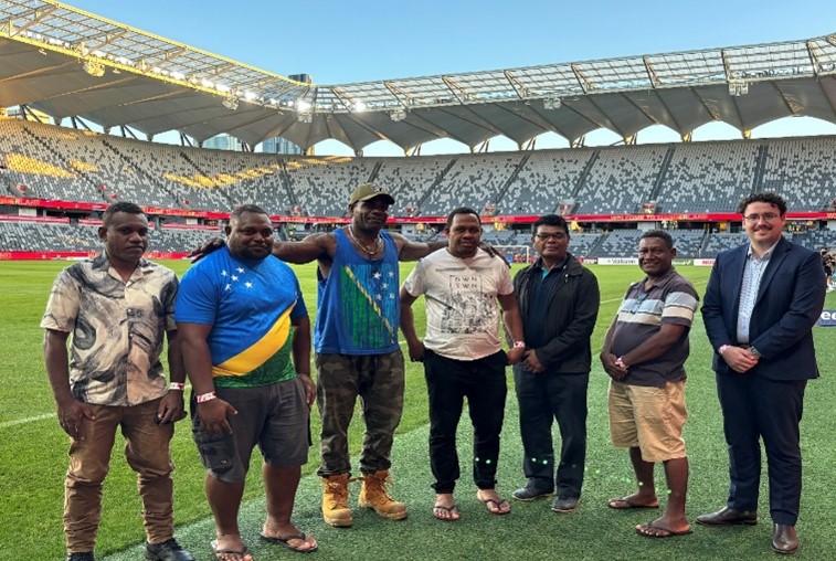 Six CFP delegates from Solomon Islands standing in the Commbank stadium lawns.