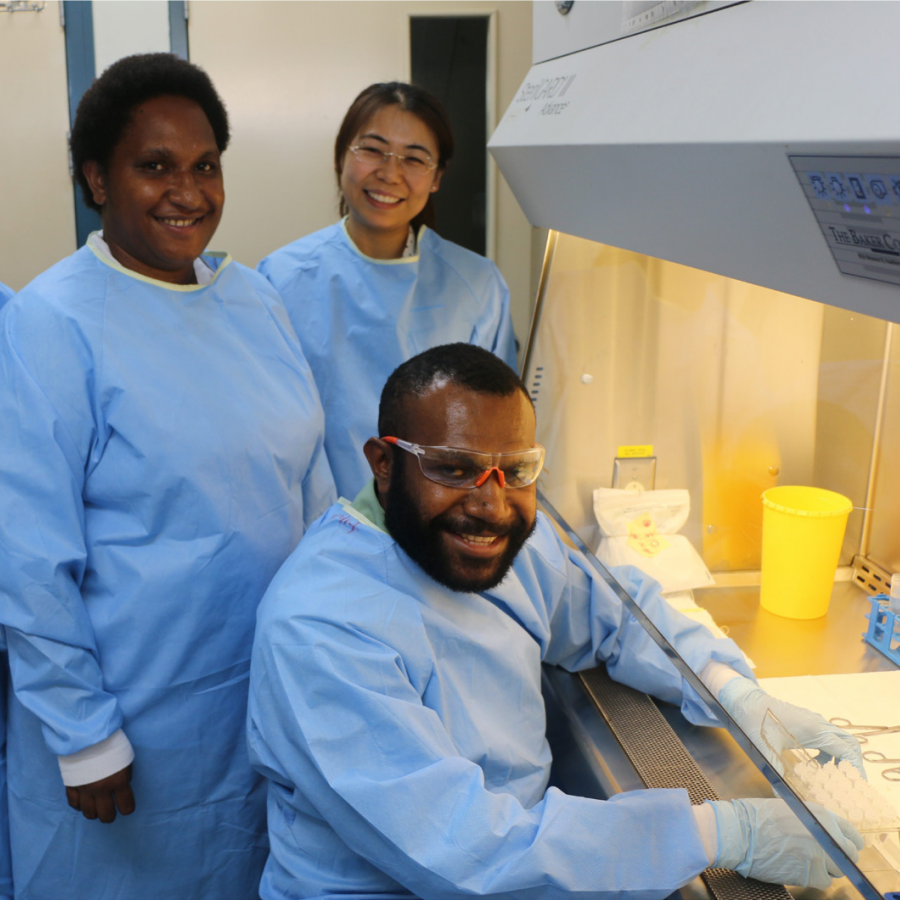 Tamarah Koleala in a lab with two other scientist