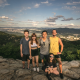 Group photo of five young people on a mountain.