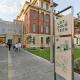 A Lot Fourteen sign, including a plan of the campus, stands at the pedestrian mall entrance.