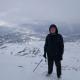 Photo of Ethan on top of a snowy mountain. 