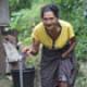 Thumbnail of Grandma Ne fetching water with a bucket