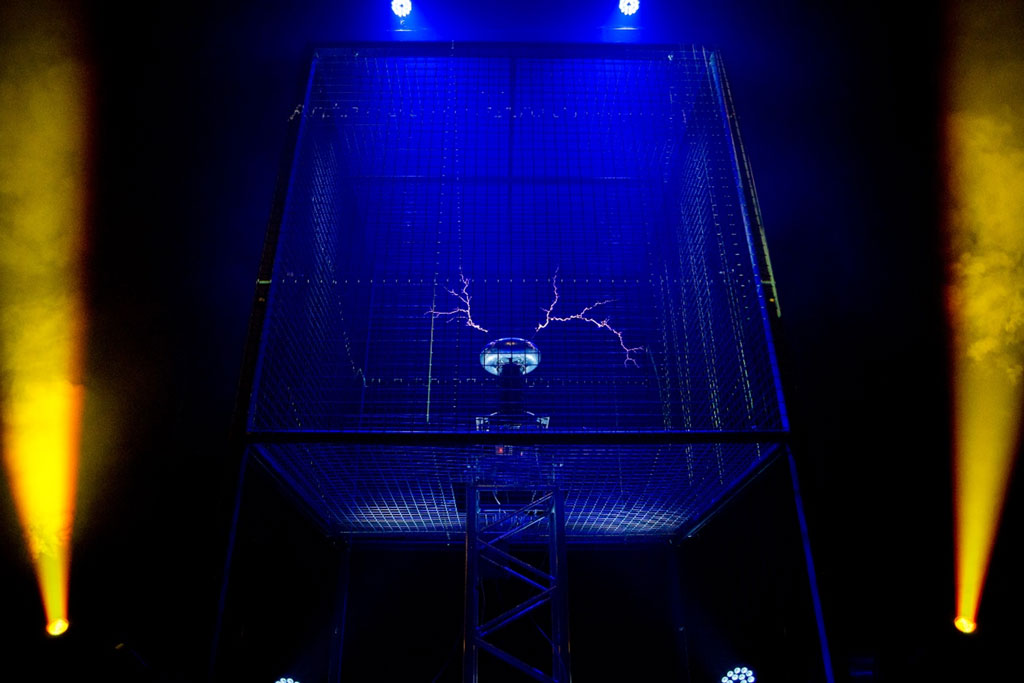 Dark room with a cage illuminated in blue light