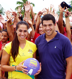 Tongan-Australian netball star Mo’onia Gerrard and her brother, international rugby star Mark Gerrard, standing in front of cheering people