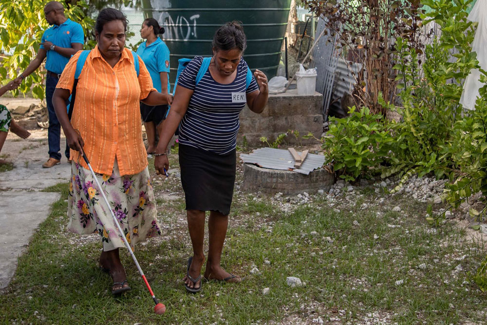 Blind woman being escorted.