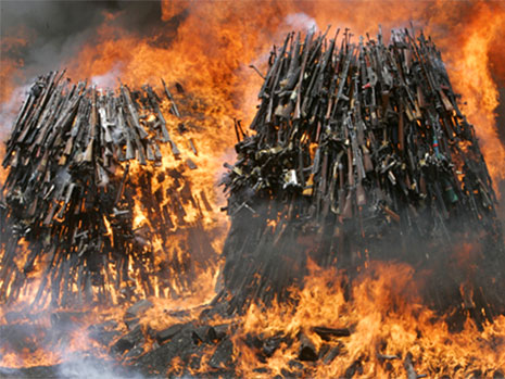 Piles of guns on fire